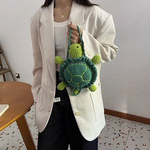 Handmade green crochet turtle handbag with intricate knit texture for girls
