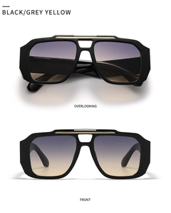 Detailansicht der schwarzen quadratischen Sonnenbrille mit goldfarbenem Steg und Verlauf