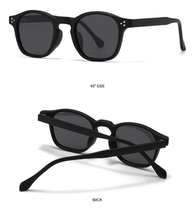 Detail view of round black polarized sunglasses with silver rivets at 45 degree angle