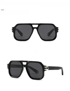 Detail view showing hexagonal metal logo on black aviator sunglasses temples