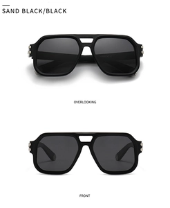 Macro view of sand black pilot frames with silver hexagonal buckle and dark lenses