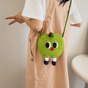 Cute apple-shaped green knitted crossbody bag with cartoon face and long legs
