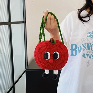 Handmade red apple crochet handbag with cartoon eyes and tiny legs decoration