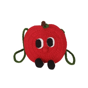 Handmade crochet apple-shaped mini crossbody bag with cartoon eyes and green leaf strap