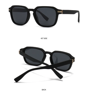 Detail view of matte black sunglasses featuring golden double bar metal hinges