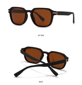 Detail of matte black polygon sunglasses with golden hinges and brown lenses