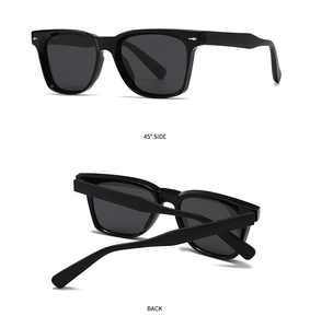 Detail view of black polygon sunglasses featuring silver metal rivets and polarized lenses