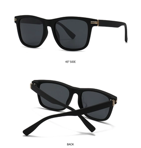 Detail view of square matte black sunglasses showing the gold metal hinge from 45 degree angle