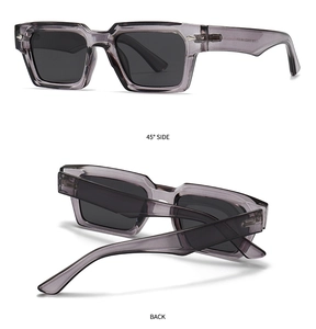 Detailed view of translucent grey rectangular sunglasses with silver metal rivets and hinges