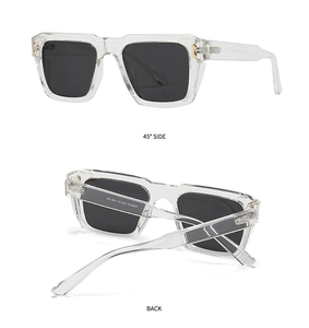 Detail view of transparent square polarized sunglasses with golden metal hinges and gray lenses
