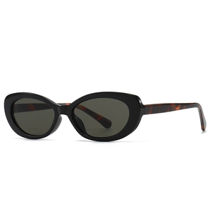 Modern vintage oval sunglasses with black frames and leopard print temples for women