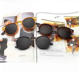 Three pairs of vintage round sunglasses on a magazine showing 100% UV400 protection detail