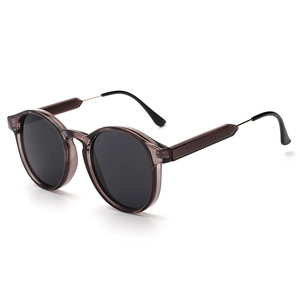 Retro sunglasses with translucent brown frames and round dark grey lenses for fashion wear