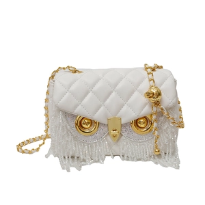 White quilted owl-shaped crossbody bag with gold chain strap and hanging bead tassels