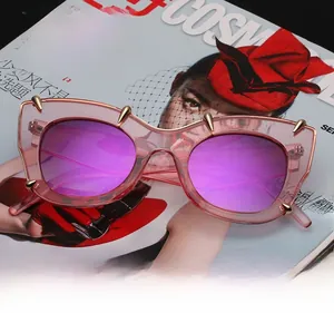 Pink translucent cat-eye sunglasses with UV400 lenses and golden stud accents