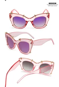 Detailed view of pink cat-eye sunglasses with purple gradient lenses and gold claw accents