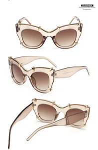 Detailed views of tea-colored cat-eye sunglasses with golden tiger tooth metal accents