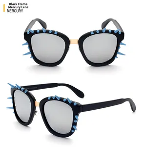 Detail of punk black frame sunglasses with silver mercury lenses and blue spiked studs