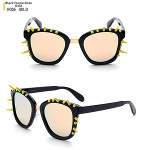 Detail of punk square sunglasses with black frame, rose gold accents and yellow spikes