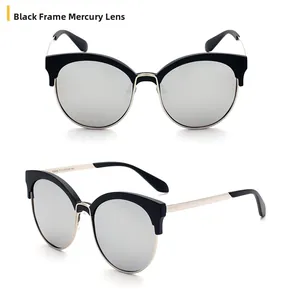 Detail of cat-eye sunglasses featuring black and gold frames with mercury silver lenses