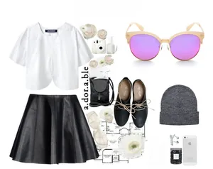 Flat lay of women's white blouse, black leather pleated skirt, and chic fashion accessories