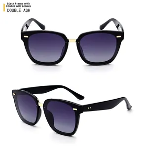 Detail of TR polarized sunglasses with black frame, gold bridge and double grey lenses
