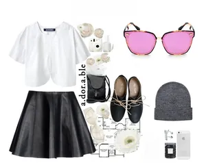 Flat lay of polarized sunglasses with white tee, leather skirt, and stylish accessories