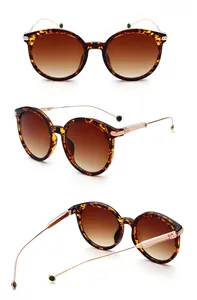 Detail view of tortoiseshell frames and gradient tea lenses on classic metal sunglasses