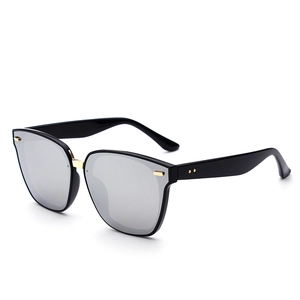 Black oversized polarized sunglasses with silver mirrored lenses and gold metal bridge