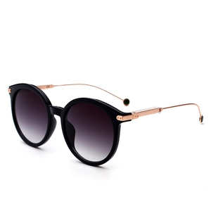 Classic round frame sunglasses with black gloss finish and rose gold metal temples
