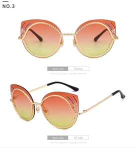 Detailweergave van gouden cat-eye zonnebril met touwstructuur en gekleurde strasstenen