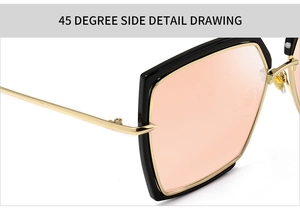 Macro view of polygon sunglasses with gold metal hinges and light orange lenses