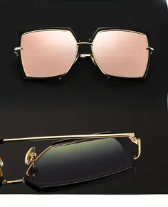 Detail of oversized sunglasses with polarized pink lenses and durable golden metal hinges