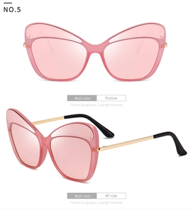 Detail view of pink cat-eye sunglasses with slim gold metal temples and clear lenses