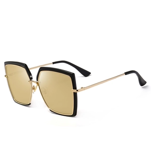 Fashionable oversized square sunglasses with black and gold frames and tea-colored lenses