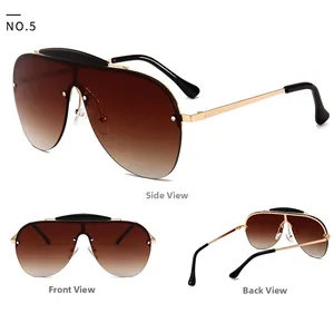 Detail view of pilot rimless sunglasses with gold metal frame and brown gradient lenses
