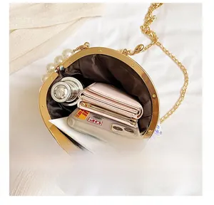 Interior detail of pearl evening bag showing space for phone, wallet and cosmetics