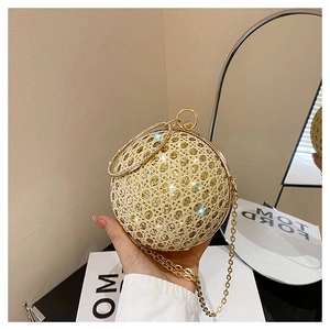 Detailed view of golden spherical evening bag featuring hollow mesh and crystal rhinestones