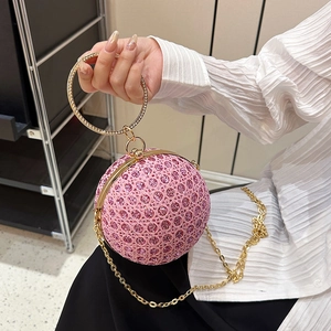 Sparkly pink spherical evening clutch bag with diamond-studded handle and gold chain strap