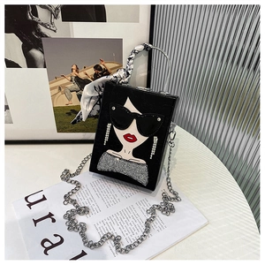 Detail of square box bag featuring fashion lady print and silk-wrapped metal handle