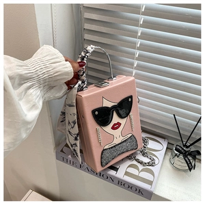 Detail of pink box bag with fashion lady print and silk scarf wrapped metal handle