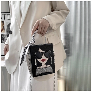 Fashionable black box bag with cartoon woman print and silk scarf handle on model