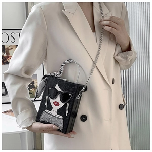 Detail of black box bag with fashion portrait, scarf handle and silver chain strap