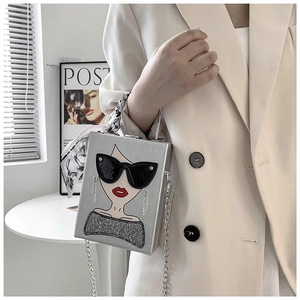 Detail of silver box bag featuring female illustration with tassel earrings and silk scarf