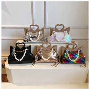 Detail of sequin tote bags with heart-shaped handles and elegant pearl chain straps