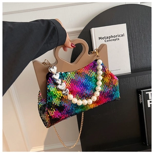 Close-up of rainbow sequin tote bag with unique heart-shaped handle and pearl charm