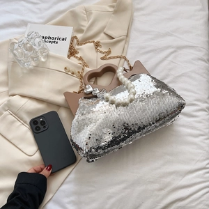 Chic silver sequin tote bag with heart-shaped wooden handle and pearl strap detail