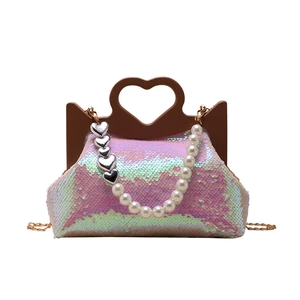 Sparkly pink sequin tote bag for women featuring a unique heart-shaped cutout handle