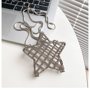 Macro detail of the star-shaped silver hollow-out metal mesh handbag with a snake chain