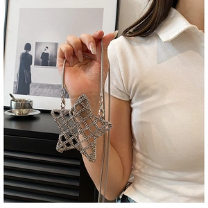 Detailed view of a silver hollow star bag with metallic mesh and elegant snake chain
